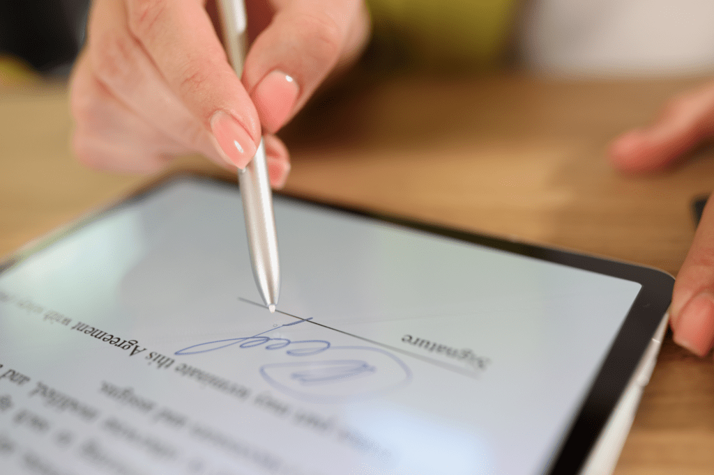 Digital signature interface on a tablet, representing the secure, verifiable proof of service in electronic process serving.