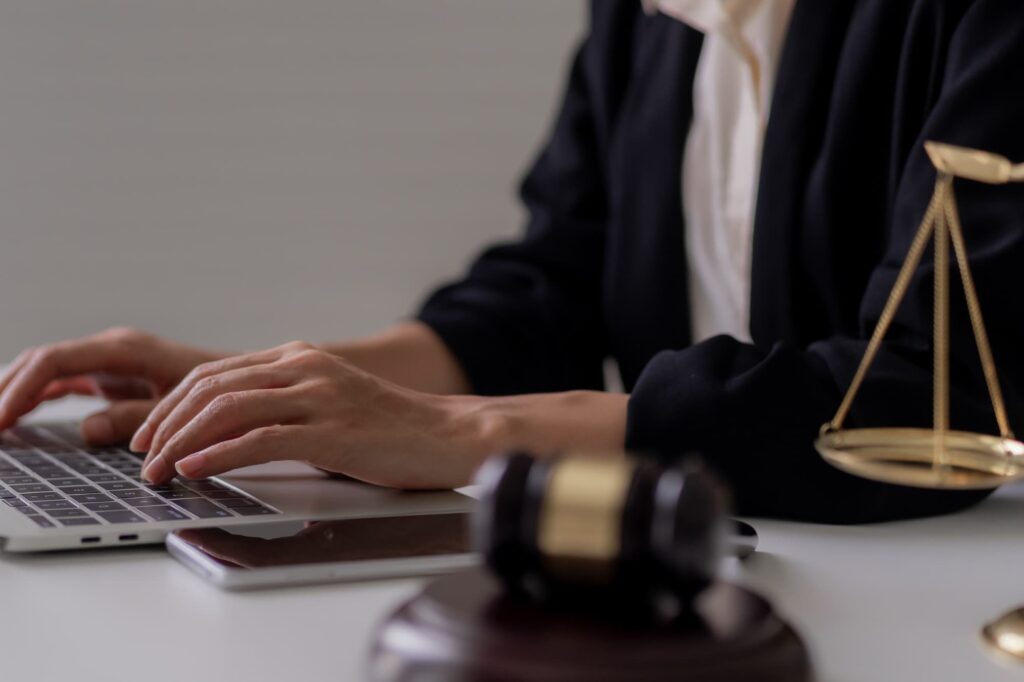 A focused attorney reviews a laptop screen, weighing the risks and rewards of partnering with a tech-driven process serving company.